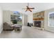 Inviting living room featuring a stone fireplace and large arched window at 304 Hibiscus St, Chuluota, FL 32766