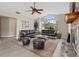 Bright living room featuring vaulted ceilings, a fireplace and large windows providing lots of natural light at 304 Hibiscus St, Chuluota, FL 32766