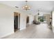 Open-concept living space featuring a stone fireplace, arch window and wood-look floors at 304 Hibiscus St, Chuluota, FL 32766