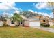 One-story home with attached garage and landscaped lawn at 623 Buckingham Dr, Oviedo, FL 32765