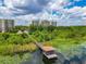 Stunning aerial view of a waterfront condo community and pier over lily pad filled lake at 6312 Buford St # 304, Orlando, FL 32835
