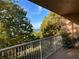 Inviting balcony view with white railings overlooking lush landscaping and distant water views at 6312 Buford St # 304, Orlando, FL 32835