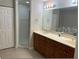 Bright bathroom features double sink vanity, with stand up shower, and walk in closet at 6312 Buford St # 304, Orlando, FL 32835