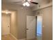 Carpeted bedroom features standard ceiling fan and entry to the closet and hallway at 6312 Buford St # 304, Orlando, FL 32835