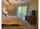 Cozy bedroom featuring a large window and balcony access, providing natural light and views at 6312 Buford St # 304, Orlando, FL 32835