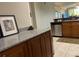 Open-concept kitchen with granite countertops, wood cabinetry, and stainless steel appliances at 6312 Buford St # 304, Orlando, FL 32835