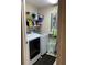 Bright laundry room with modern washer, dryer, shelving, and storage solutions at 6312 Buford St # 304, Orlando, FL 32835