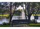A park bench with a view of the tranquil community pond and fountain at 6312 Buford St # 304, Orlando, FL 32835