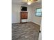 Cozy bedroom with wood-like tile floors and a tv at 1501 Noble St, Longwood, FL 32750