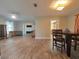 Bright dining room with wood-look floors and view to kitchen at 1501 Noble St, Longwood, FL 32750