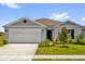 Charming single-story home with a two-car garage, well-maintained lawn, and stylish neutral color palette at 2812 Gabion St, Bartow, FL 33830