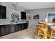 Kitchen features dark wood cabinets, a breakfast bar, and tile flooring at 3109 Sky St, Deltona, FL 32738