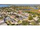 An aerial view of the house in a serene neighborhood; featuring backyard pools, lush trees, and proximity to the lake at 7305 Grotto Ave, Orlando, FL 32812