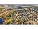 An aerial view of the neighborhood with beautiful pond views, shopping, and mature landscaping, located in a desirable area at 7305 Grotto Ave, Orlando, FL 32812