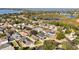 An aerial view of the houses in a serene neighborhood; featuring backyard pools, lush trees, and proximity to the lake at 7305 Grotto Ave, Orlando, FL 32812