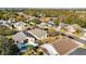 An aerial view of houses in a quiet neighborhood near a lake at 7305 Grotto Ave, Orlando, FL 32812