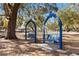 Park benches set in a peaceful park with mature trees and a volleyball court at 7305 Grotto Ave, Orlando, FL 32812