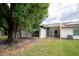 View of home's backyard with screened in lanai at 962 Oropesa Ave, Orlando, FL 32807