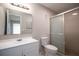 Updated bathroom featuring new vanity, toilet, mirror and walk-in shower at 962 Oropesa Ave, Orlando, FL 32807