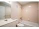 Bathroom featuring tub and shower combination with vanity and neutral tile at 962 Oropesa Ave, Orlando, FL 32807