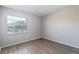 A bright bedroom with a window and wood-look flooring at 962 Oropesa Ave, Orlando, FL 32807