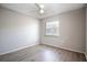 Comfortable bedroom with wood-look floors, a ceiling fan, and natural light from the window at 962 Oropesa Ave, Orlando, FL 32807