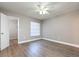 Inviting bedroom featuring wood-look floors, neutral paint, and a ceiling fan at 962 Oropesa Ave, Orlando, FL 32807