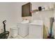 Convenient laundry room with washer, dryer, and overhead storage at 1162 Alder Tree Dr, Apopka, FL 32703