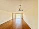 Large living room featuring wood-look flooring and a view of the lake at 13803 Fairway Island Dr # 1627, Orlando, FL 32837
