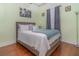 Guest bedroom with wood-look floors and gray bedding at 290 Thomas Dr, Casselberry, FL 32707