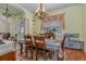 Bright dining room features a wood table and chairs, chandelier, and decorative window treatments at 290 Thomas Dr, Casselberry, FL 32707