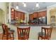 Kitchen boasts dark wood cabinetry, granite countertops, and a breakfast bar with seating at 290 Thomas Dr, Casselberry, FL 32707