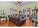 Relaxing living room features a large brown sectional sofa and access to backyard at 290 Thomas Dr, Casselberry, FL 32707