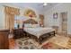 Main bedroom with king-size bed, wood furniture, and ensuite bathroom access at 290 Thomas Dr, Casselberry, FL 32707