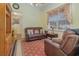 Cozy sitting room with leather furniture and a view into the bathroom at 290 Thomas Dr, Casselberry, FL 32707