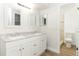 Modern bathroom showcasing a double vanity with elegant white cabinets and granite countertops at 666 Sausalito Blvd, Casselberry, FL 32707