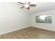 Light-filled bedroom with wood-look floors, ceiling fan, and a view of the outdoors at 666 Sausalito Blvd, Casselberry, FL 32707