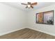 Bright bedroom featuring hardwood floors, a window, and a ceiling fan at 666 Sausalito Blvd, Casselberry, FL 32707