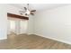 Spacious bedroom with wood-look flooring and a ceiling fan; view of the en suite bathroom at 666 Sausalito Blvd, Casselberry, FL 32707