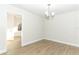 Light-filled dining room with wood-look floors; view of doorway to an adjacent room at 666 Sausalito Blvd, Casselberry, FL 32707