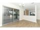 Dining area features wood-look floors and a stone accent wall adjacent to the enclosed porch at 666 Sausalito Blvd, Casselberry, FL 32707