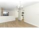 Open dining area with wood floors; view of the kitchen and a stone accent wall at 666 Sausalito Blvd, Casselberry, FL 32707