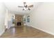 Spacious living room features a stone fireplace, ceiling fan and wood-look floors at 666 Sausalito Blvd, Casselberry, FL 32707