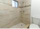 Shower area with tile surround, new showerhead, and updated fixtures at 666 Sausalito Blvd, Casselberry, FL 32707