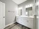 Double vanity bathroom with gray walls and white cabinets at 845 Land Ave, Longwood, FL 32750