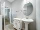 Stylish bathroom with pedestal sink and ornate cabinet at 845 Land Ave, Longwood, FL 32750