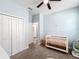 Light-filled bedroom with double doors and a crib at 845 Land Ave, Longwood, FL 32750