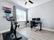 Bright home office featuring a Peloton bike and workspace at 845 Land Ave, Longwood, FL 32750