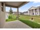 Covered patio views a spacious, fenced backyard, showcasing the home's exterior at 8626 Caribbean Pine Way, Lakeland, FL 33809