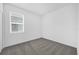 Bedroom features neutral carpet, white walls, and a window with natural light at 8626 Caribbean Pine Way, Lakeland, FL 33809